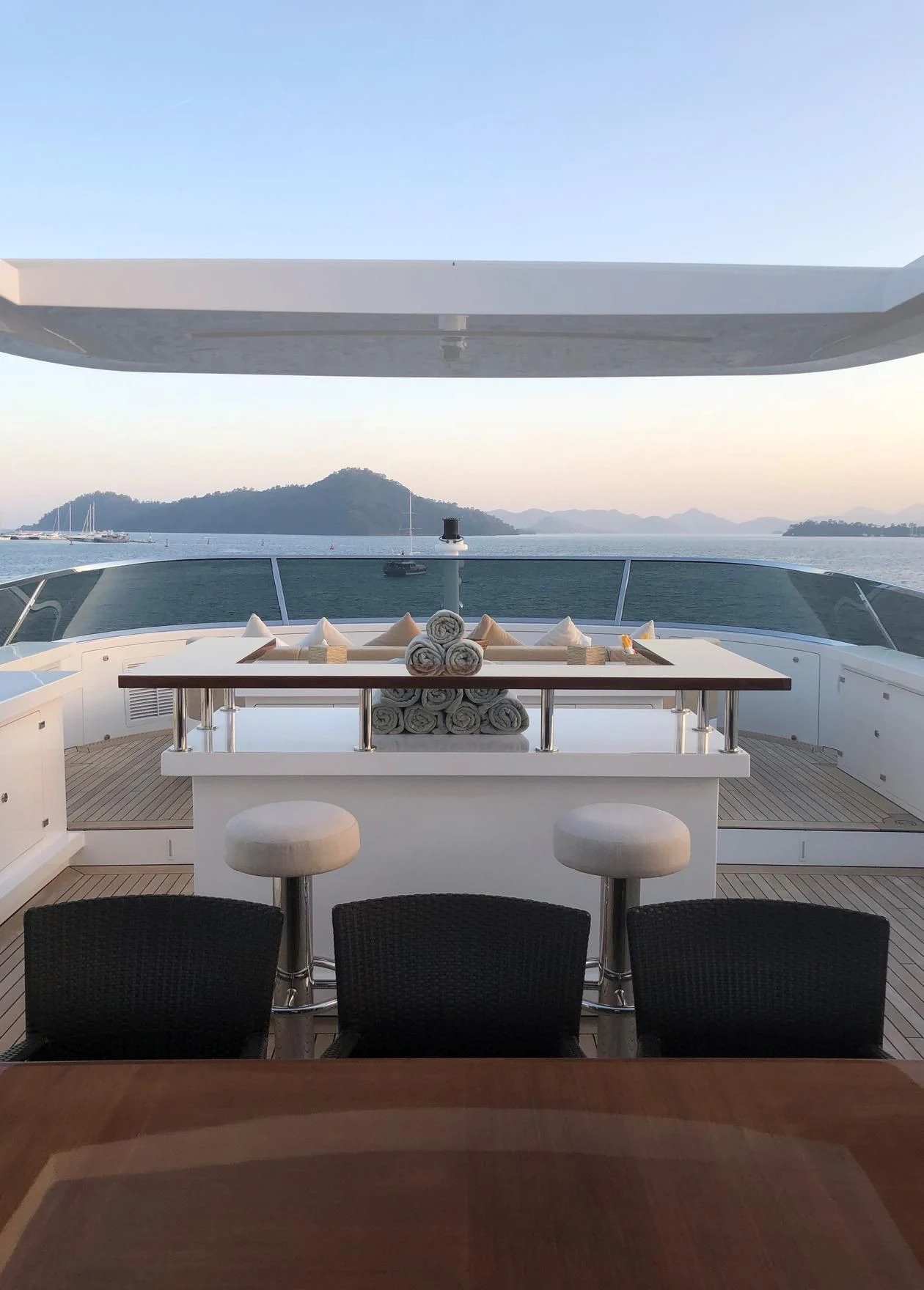 a table with chairs and a view of the water aboard ORYX Yacht for Sale
