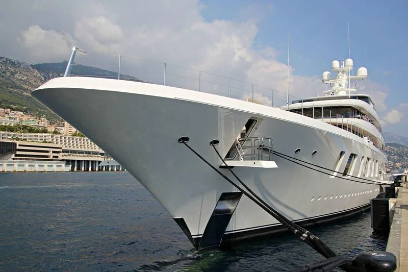 a large white yacht docked aboard AQUARIUS Yacht for Sale