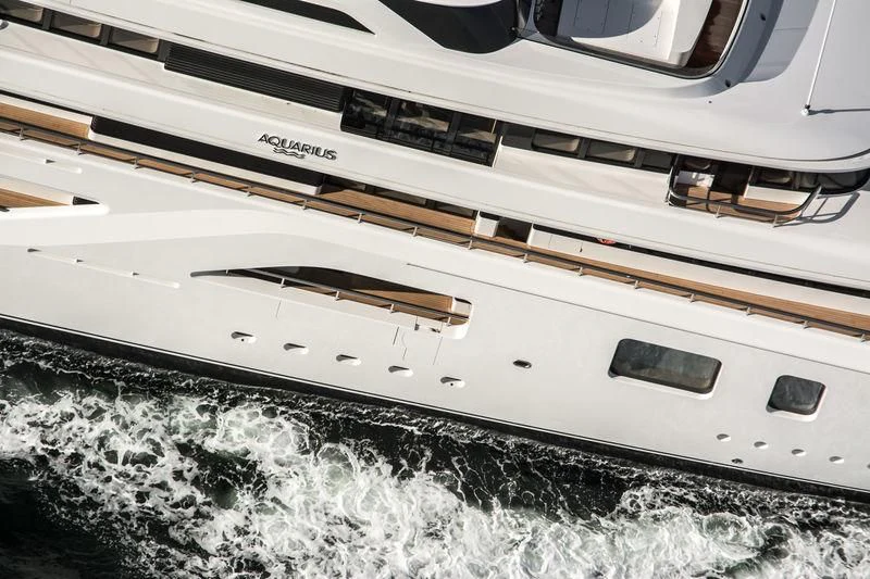 a white boat with a black stripe aboard AQUARIUS Yacht for Sale