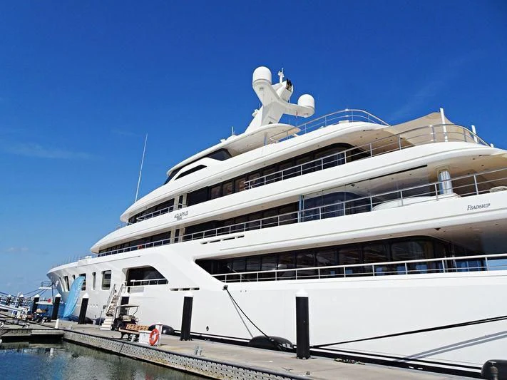 a large cruise ship docked aboard AQUARIUS Yacht for Sale