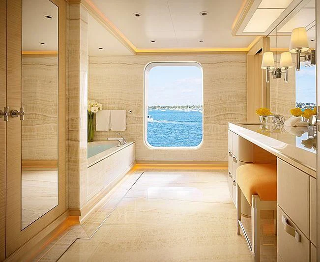 a bathroom with a tub sink and cabinets aboard AQUARIUS Yacht for Sale