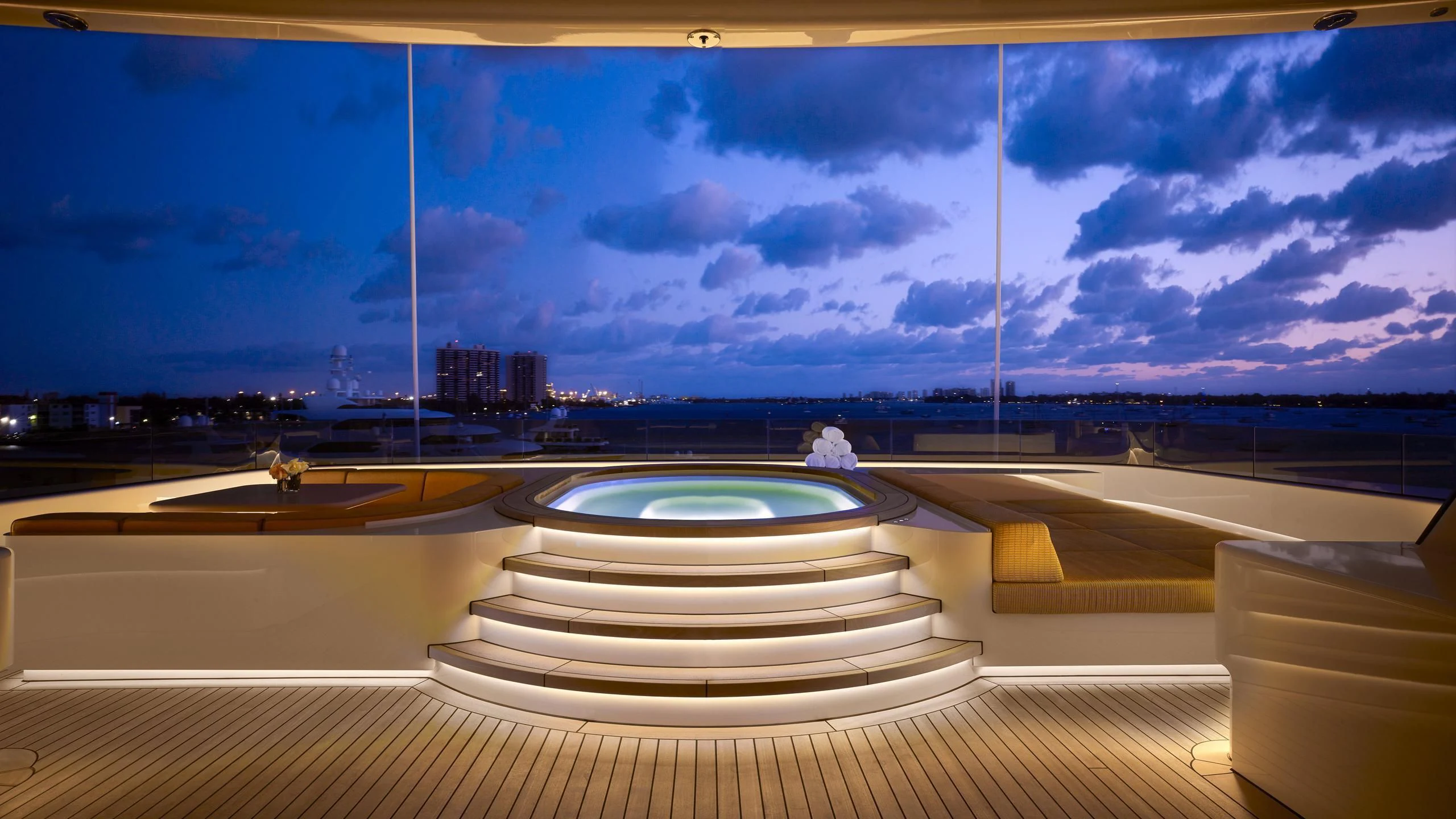 a large pool with a large building in the background aboard AQUARIUS Yacht for Sale