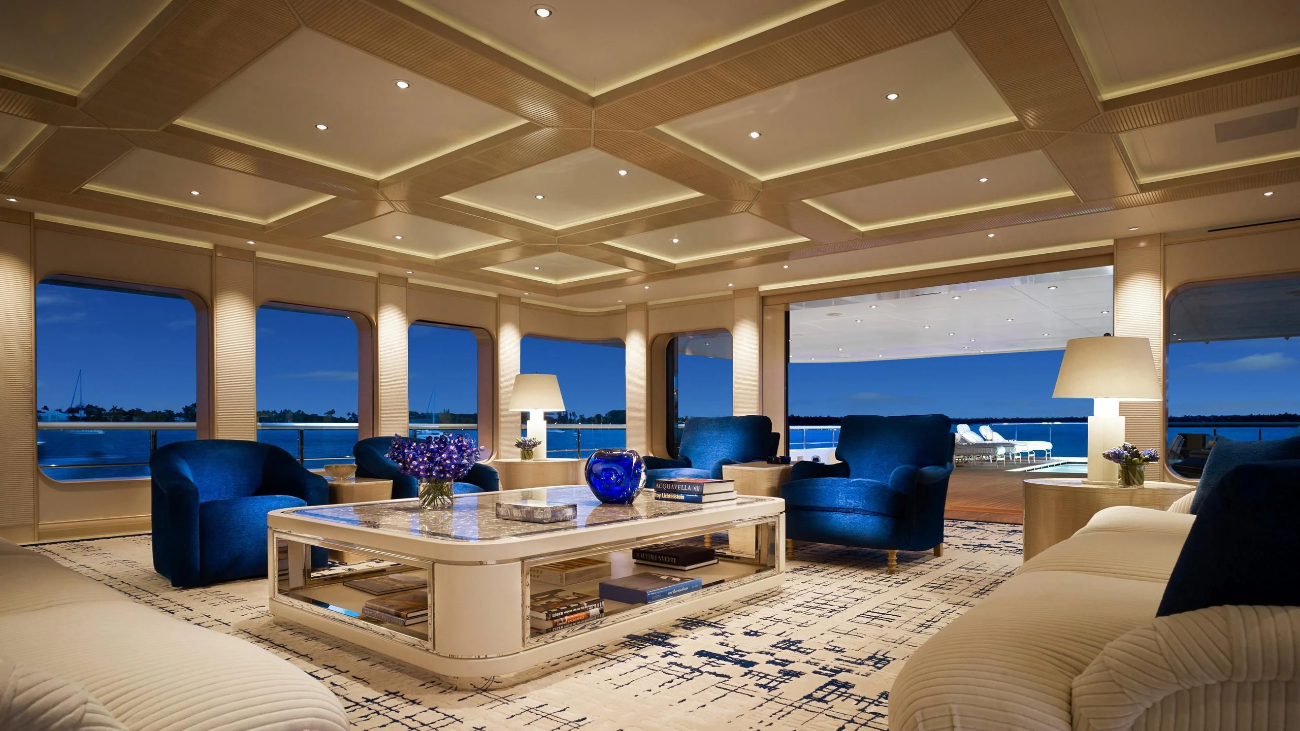 a large living room with a large table and chairs aboard AQUARIUS Yacht for Sale