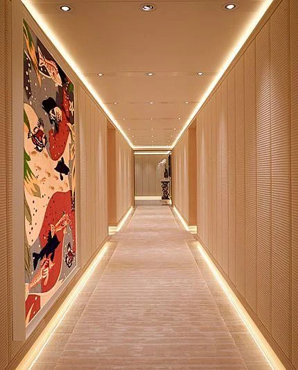 a long hallway with posters on the wall aboard AQUARIUS Yacht for Sale