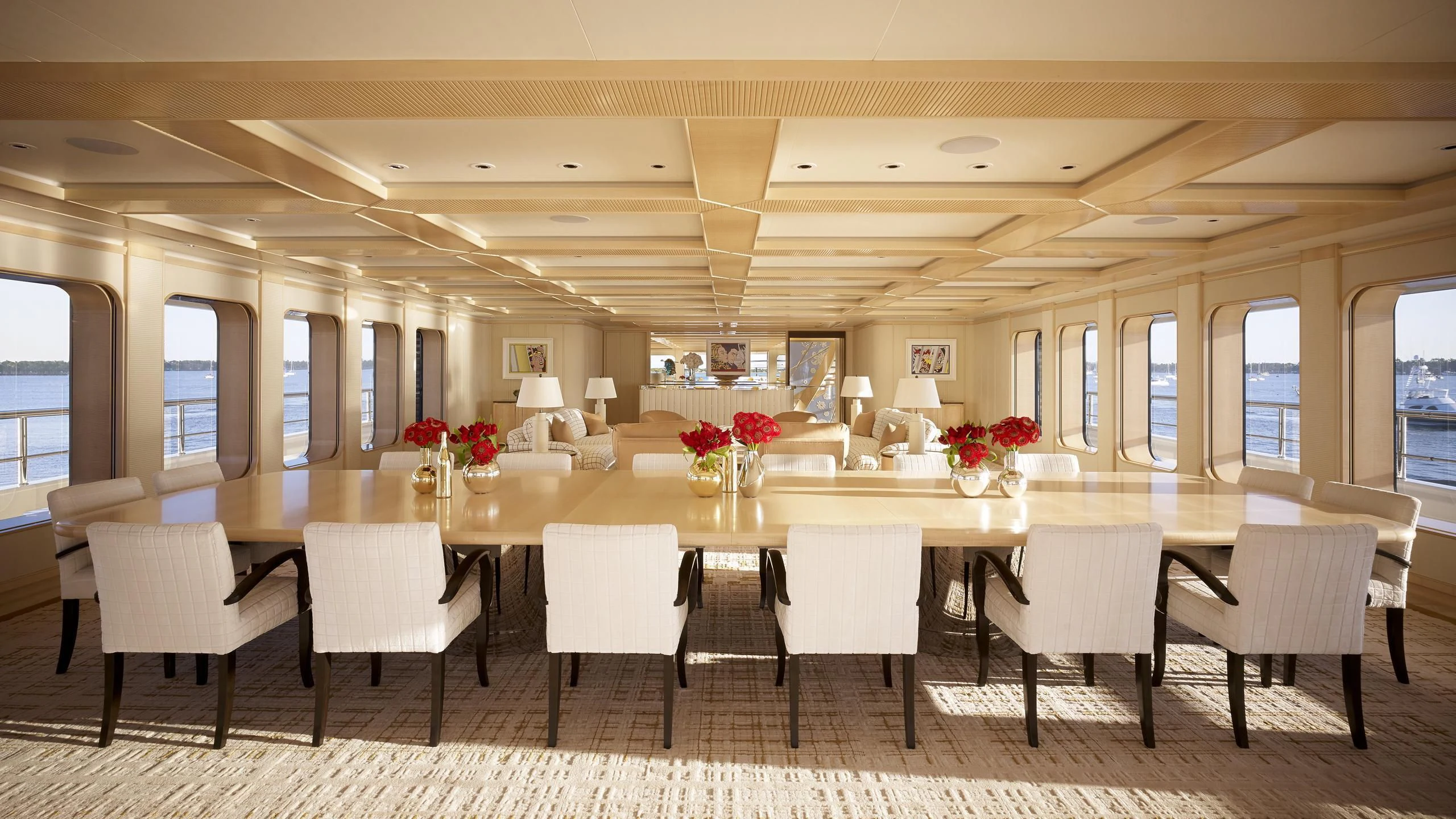 a large dining room with white chairs aboard AQUARIUS Yacht for Sale