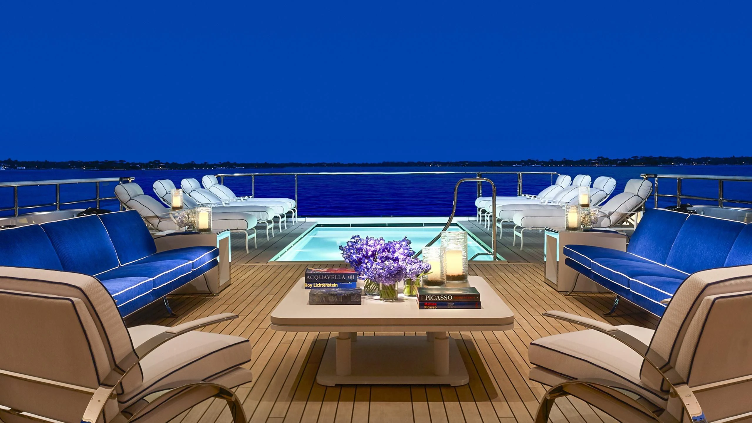 a pool with a deck and chairs aboard AQUARIUS Yacht for Sale