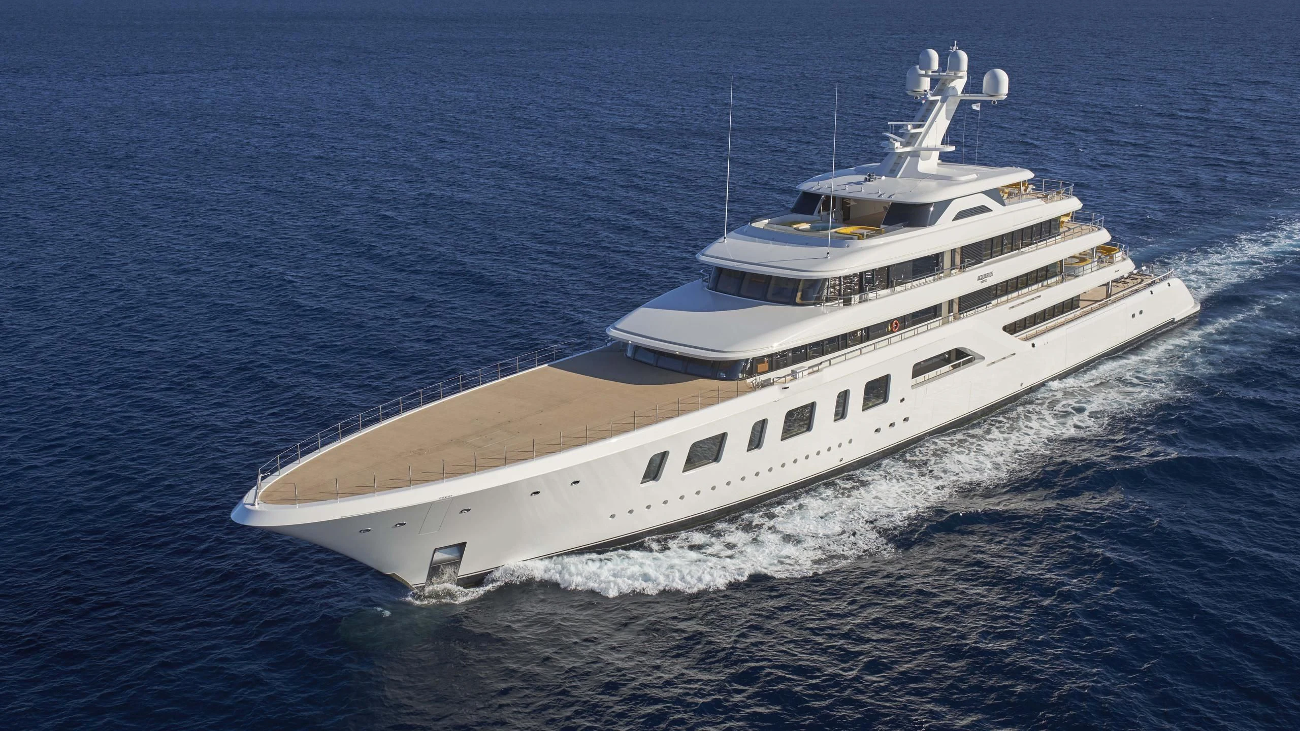 a white boat on the water aboard AQUARIUS Yacht for Sale