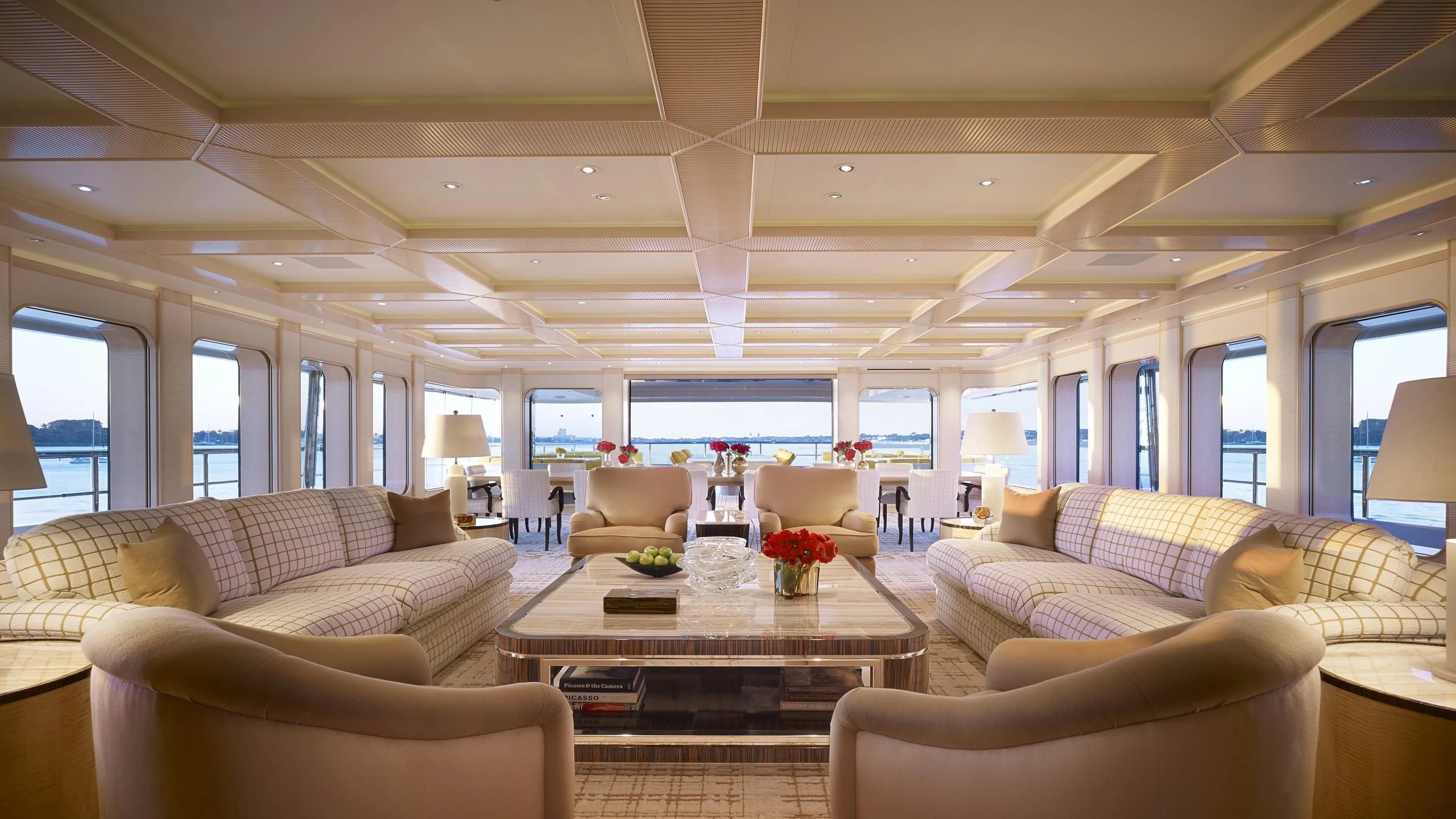 a living room with a table and chairs aboard AQUARIUS Yacht for Sale