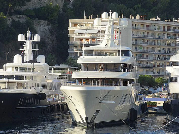 a large white boat sits in the water aboard AQUARIUS Yacht for Sale