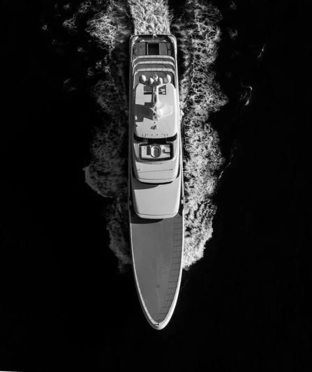 a remote control on a black surface aboard AQUARIUS Yacht for Sale