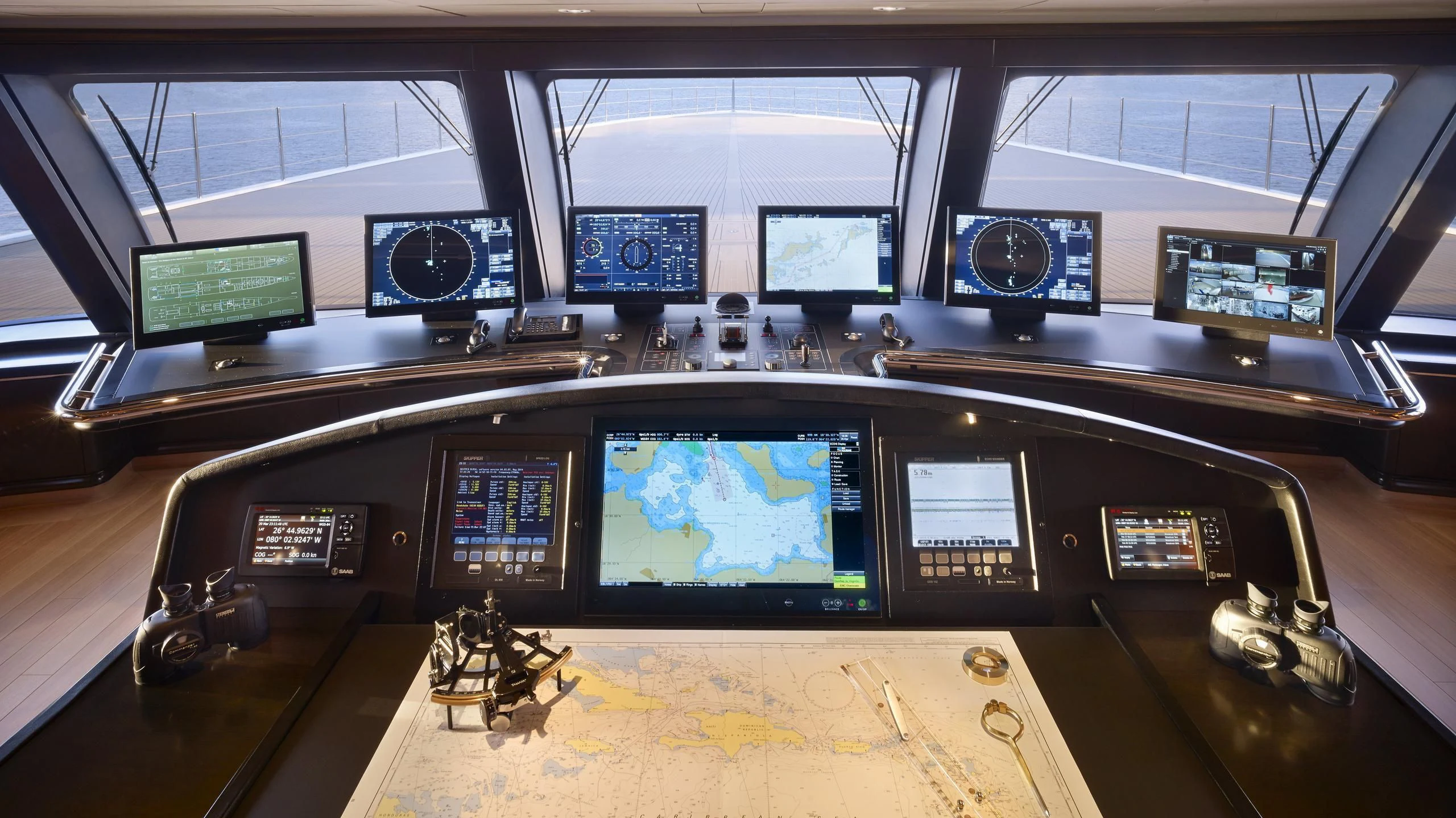 a control panel with many monitors aboard AQUARIUS Yacht for Sale