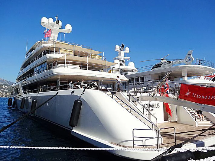 a large white ship docked aboard AQUARIUS Yacht for Sale