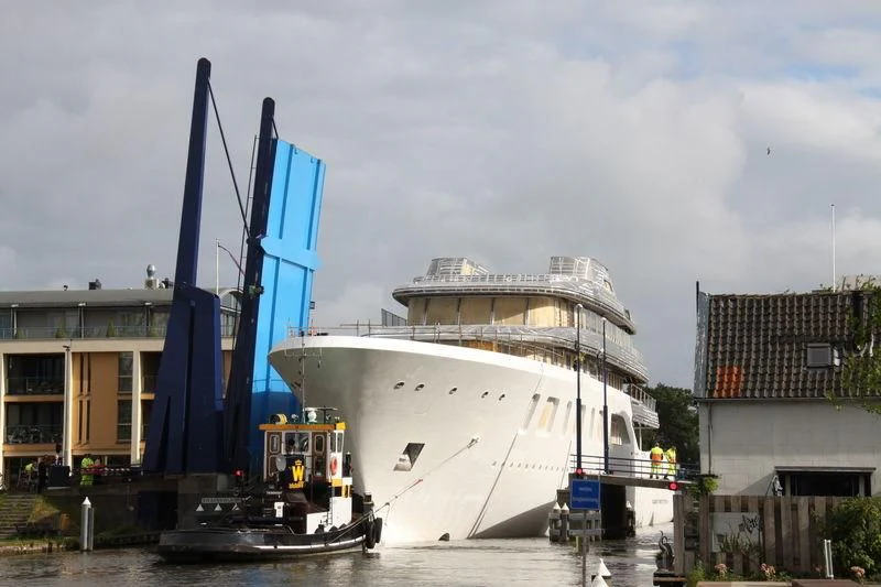 a large blue crane next to a boat aboard AQUARIUS Yacht for Sale