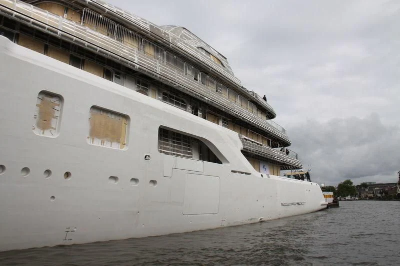 a large white boat on the water aboard AQUARIUS Yacht for Sale