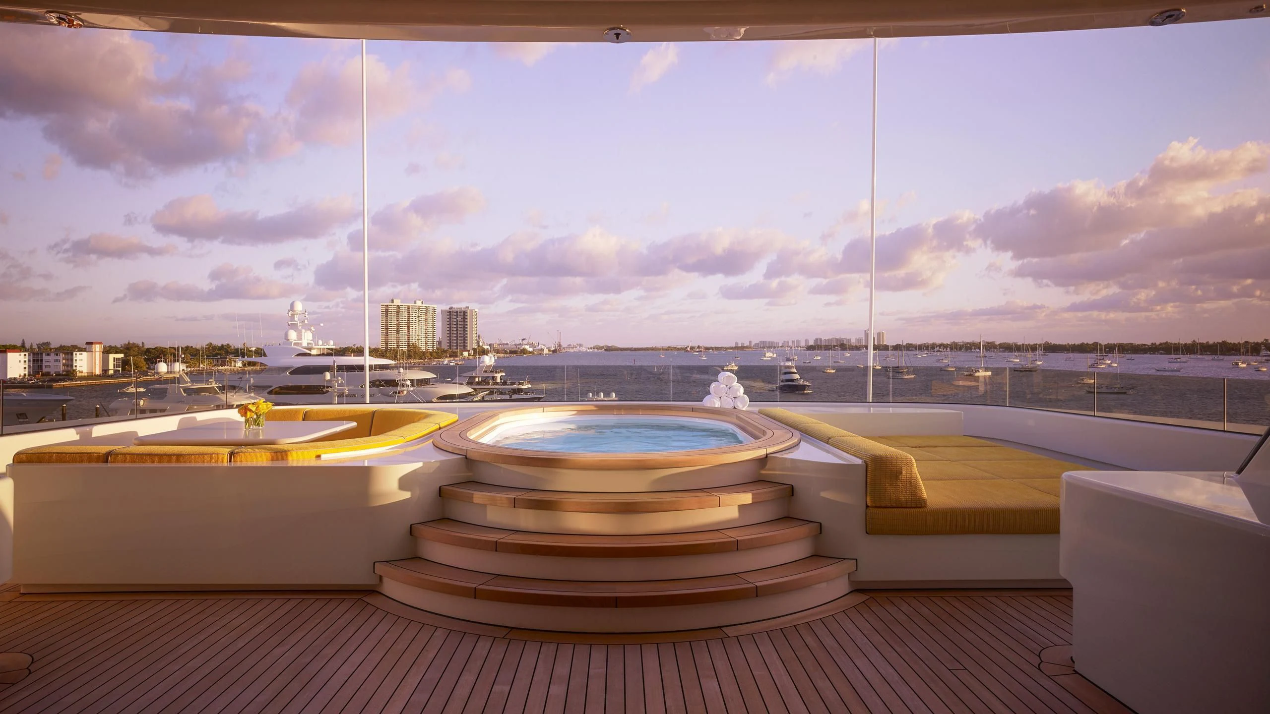 a room with a view of a city and a body of water aboard AQUARIUS Yacht for Sale