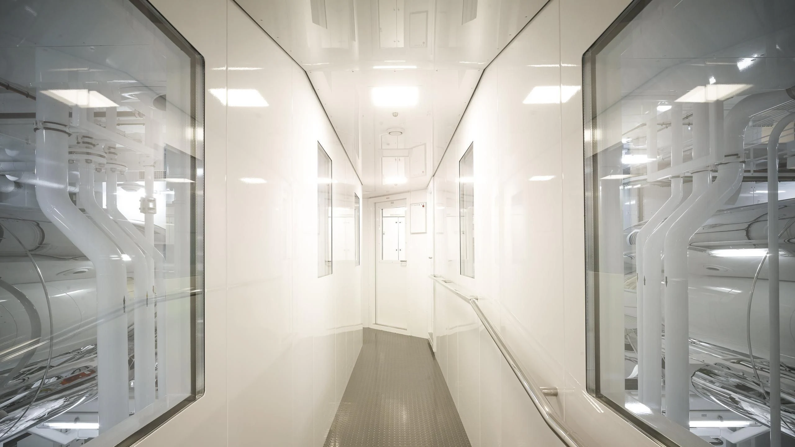 a hallway with many glass doors aboard AQUARIUS Yacht for Sale