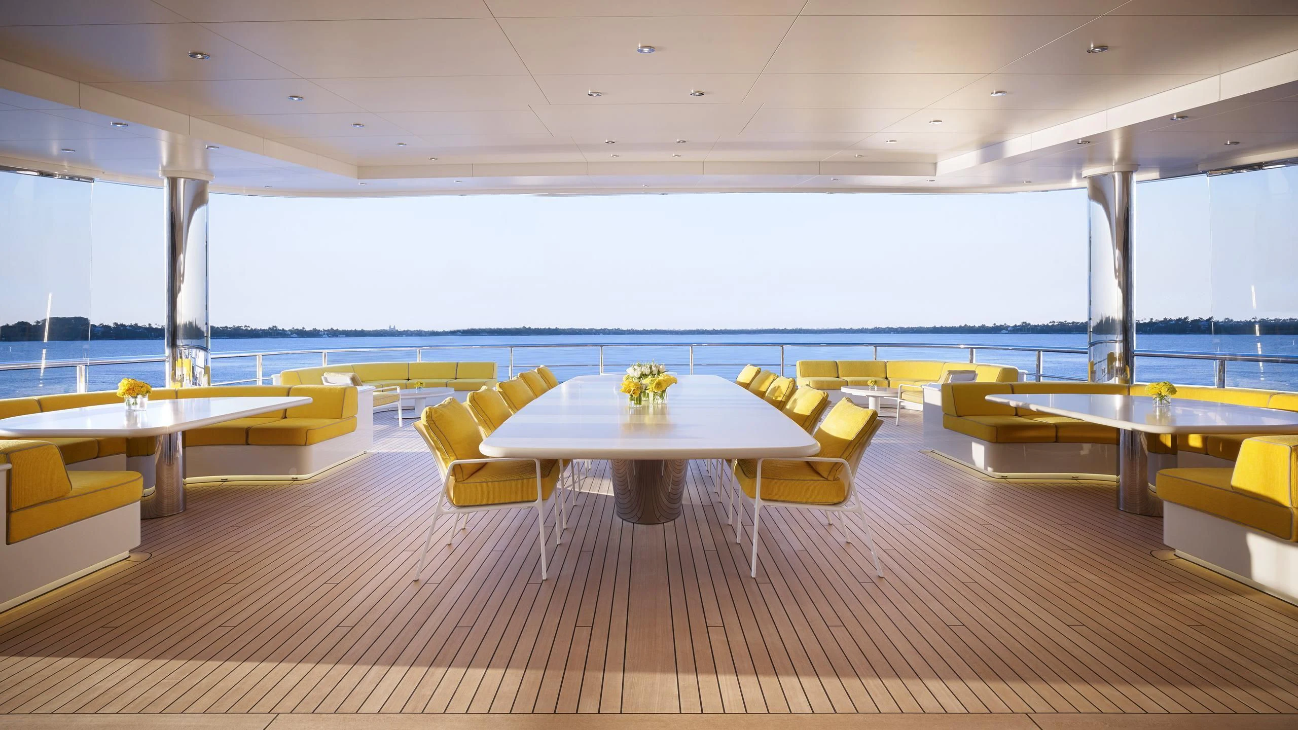 a room with tables and chairs aboard AQUARIUS Yacht for Sale