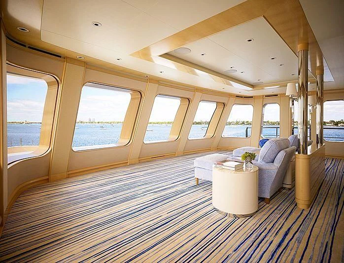 a large living room with a large window aboard AQUARIUS Yacht for Sale