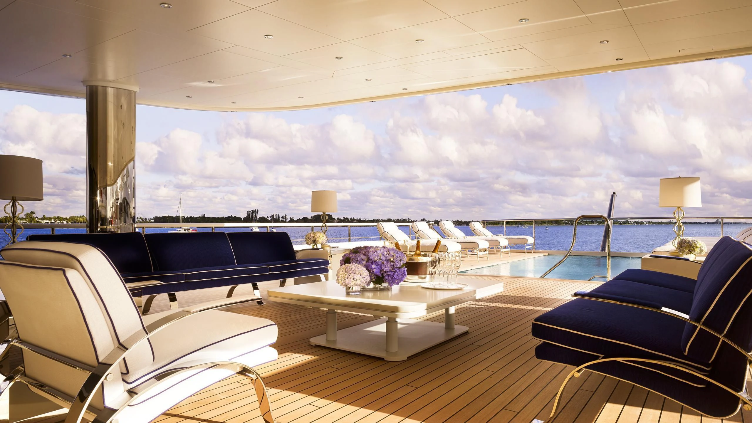 a large living room with a large balcony overlooking the ocean aboard AQUARIUS Yacht for Sale