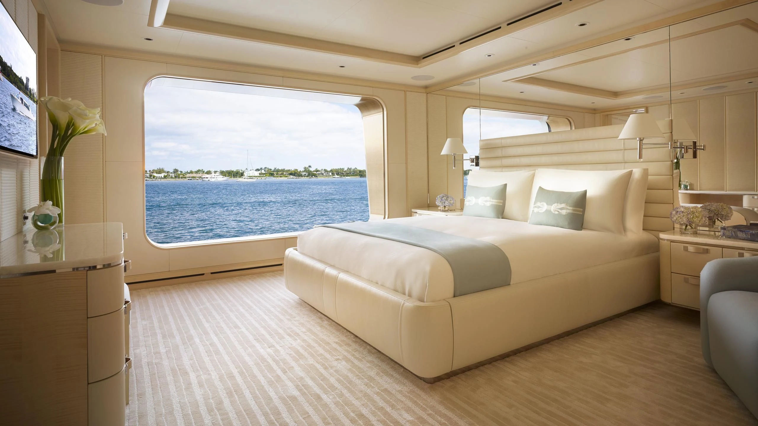 a large bed in a room aboard AQUARIUS Yacht for Sale