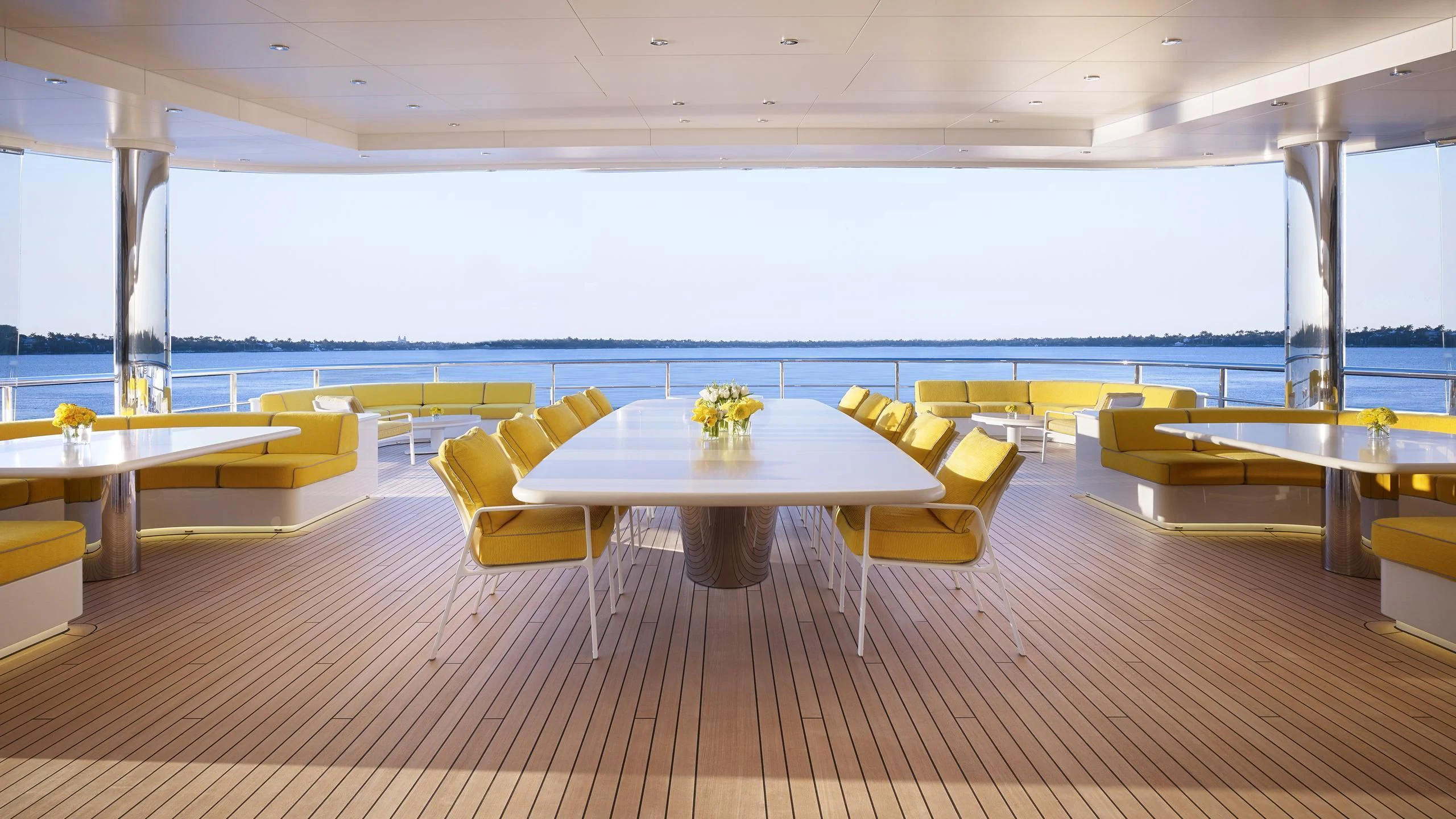 a room with tables and chairs aboard AQUARIUS Yacht for Sale