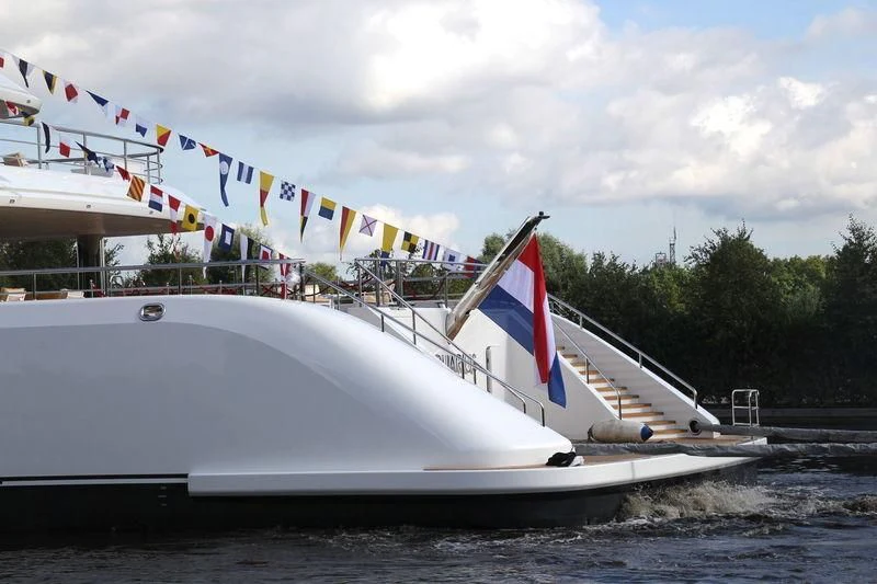 a large white boat with flags on it aboard AQUARIUS Yacht for Sale