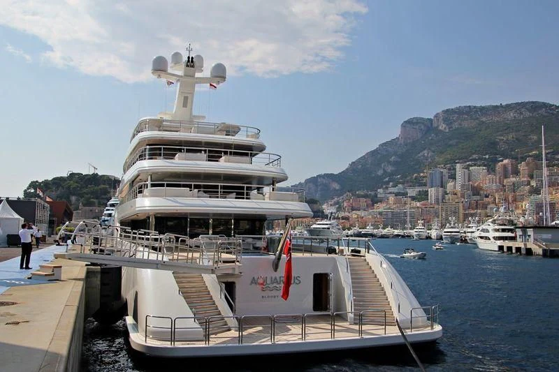 a large ship docked at a pier aboard AQUARIUS Yacht for Sale