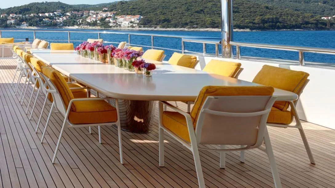 a table and chairs on a deck aboard AQUARIUS Yacht for Sale