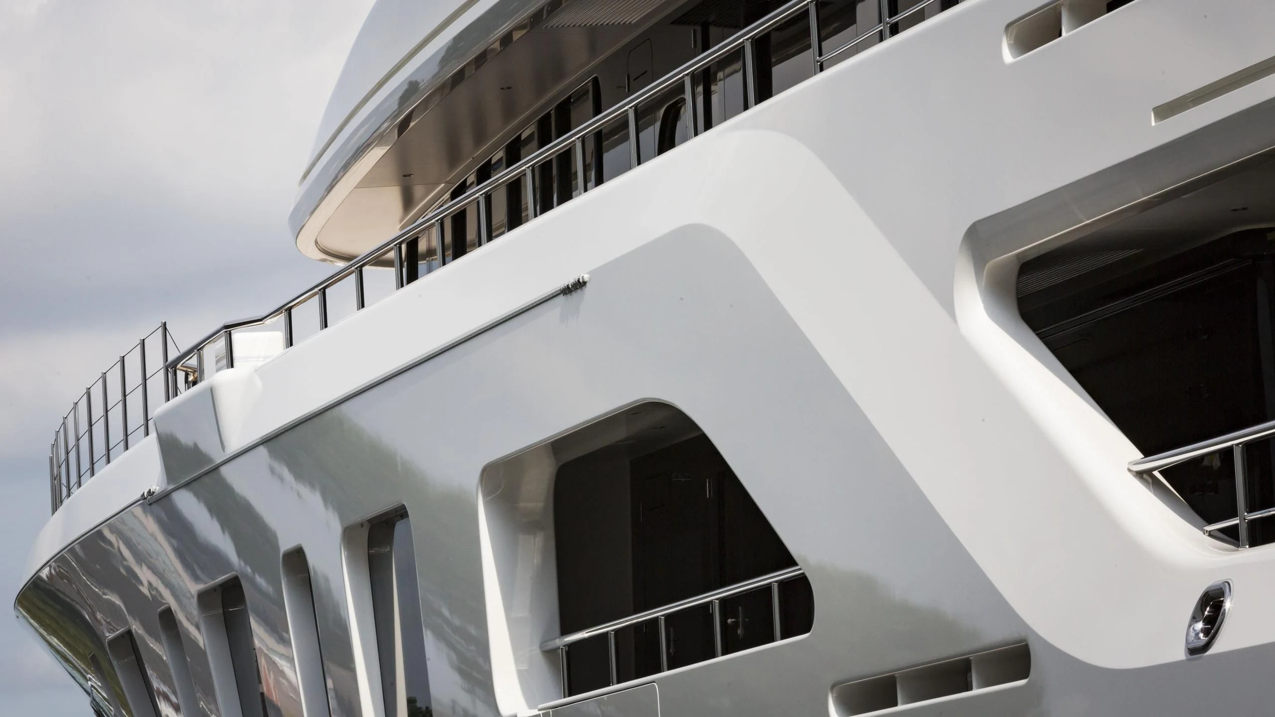 a white building with a black and white staircase aboard AQUARIUS Yacht for Sale