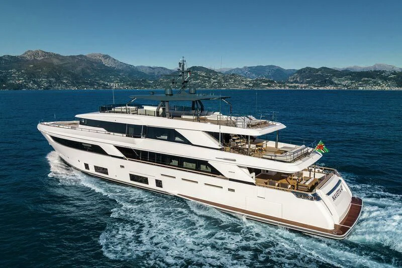 a large white boat in the water aboard NIMIR Yacht for Sale