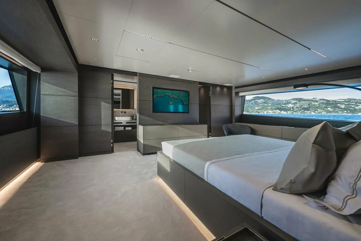 a room with a bed and a tv on the wall aboard NIMIR Yacht for Sale