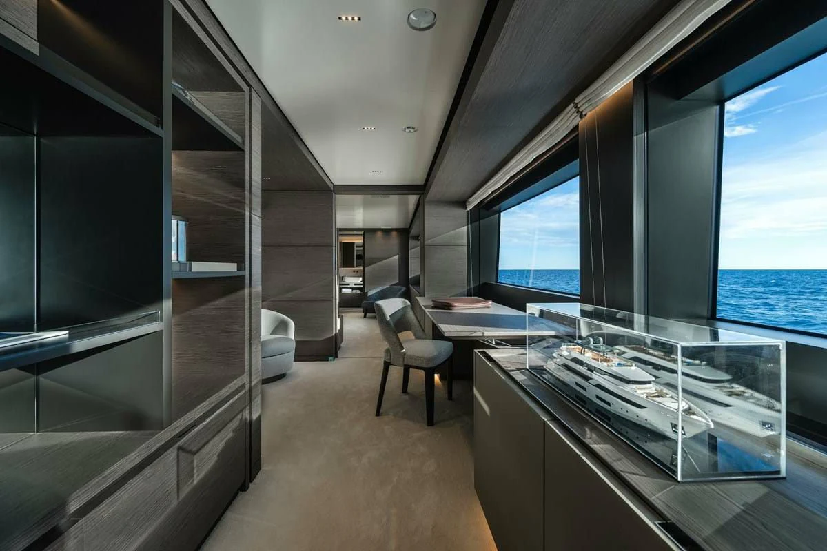 a room with a large glass display case and a large window aboard NIMIR Yacht for Sale