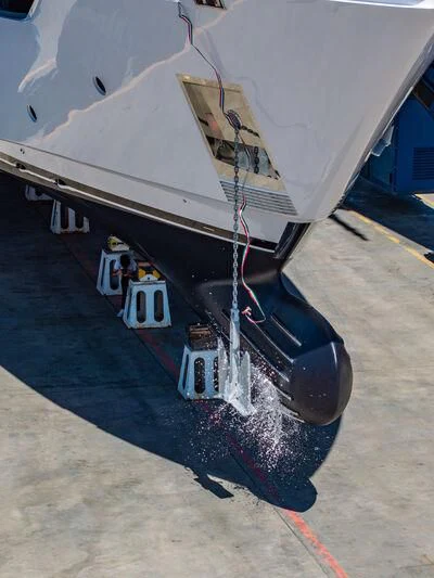 a white and black boat on a trailer aboard NIMIR Yacht for Sale