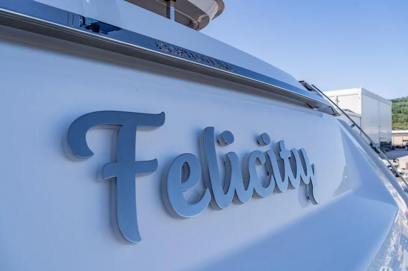 a white car with a blue sign aboard NIMIR Yacht for Sale