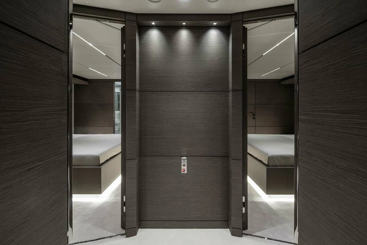 a room with a bed and a desk aboard NIMIR Yacht for Sale