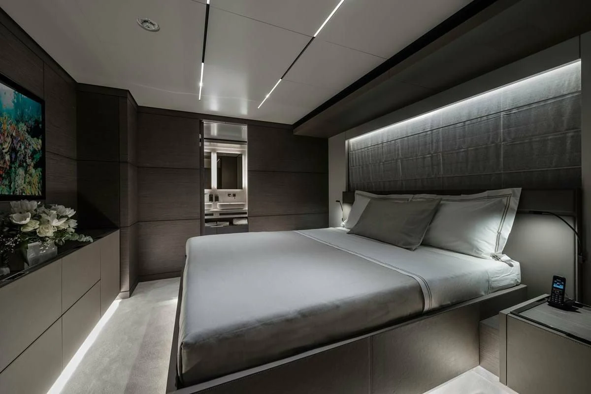 a room with a bed and a desk aboard NIMIR Yacht for Sale