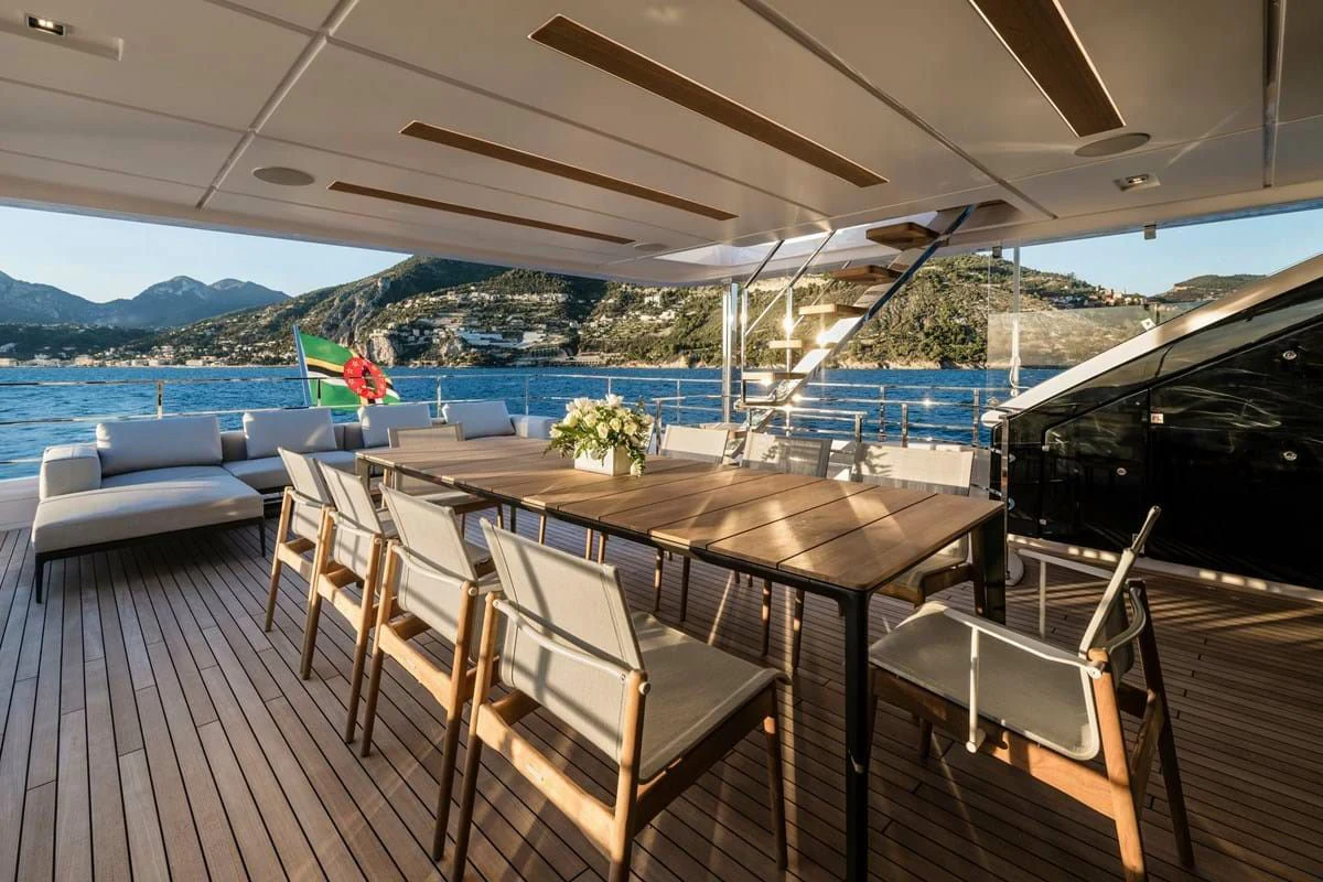 a deck with a table and chairs aboard NIMIR Yacht for Sale