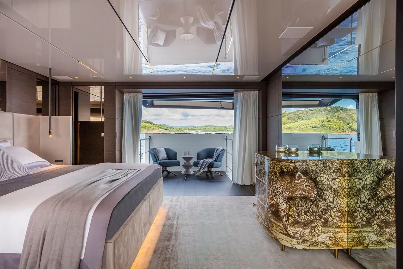 a room with a bed and a table aboard NIMIR Yacht for Sale