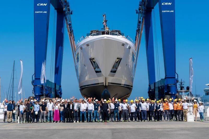 a group of people standing in front of a large ship aboard NIMIR Yacht for Sale