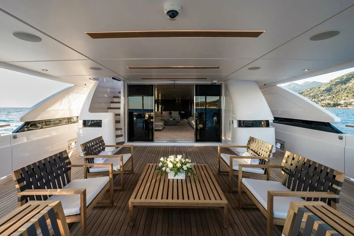 a room with tables and chairs aboard NIMIR Yacht for Sale
