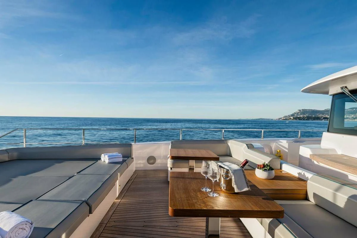 a deck with a table and chairs on it aboard NIMIR Yacht for Sale
