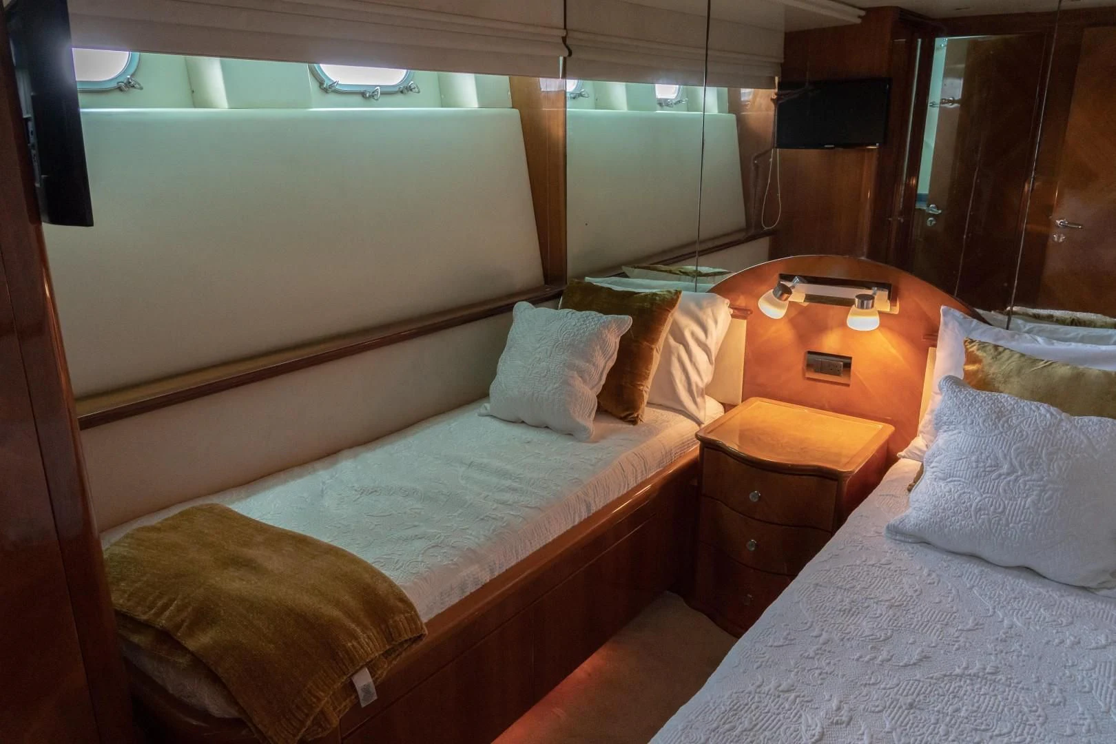 a room with beds and a table aboard EL CAPRICHO Yacht for Sale