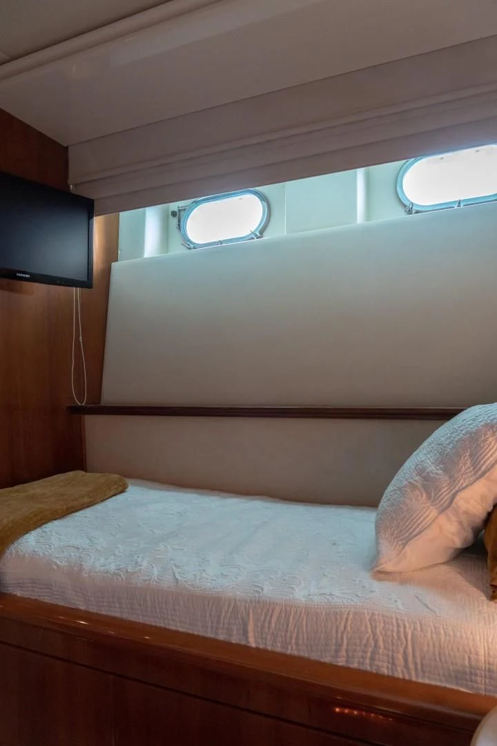 a bed with a white comforter aboard EL CAPRICHO Yacht for Sale