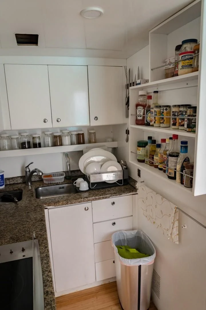 a kitchen with white cabinets aboard EL CAPRICHO Yacht for Sale