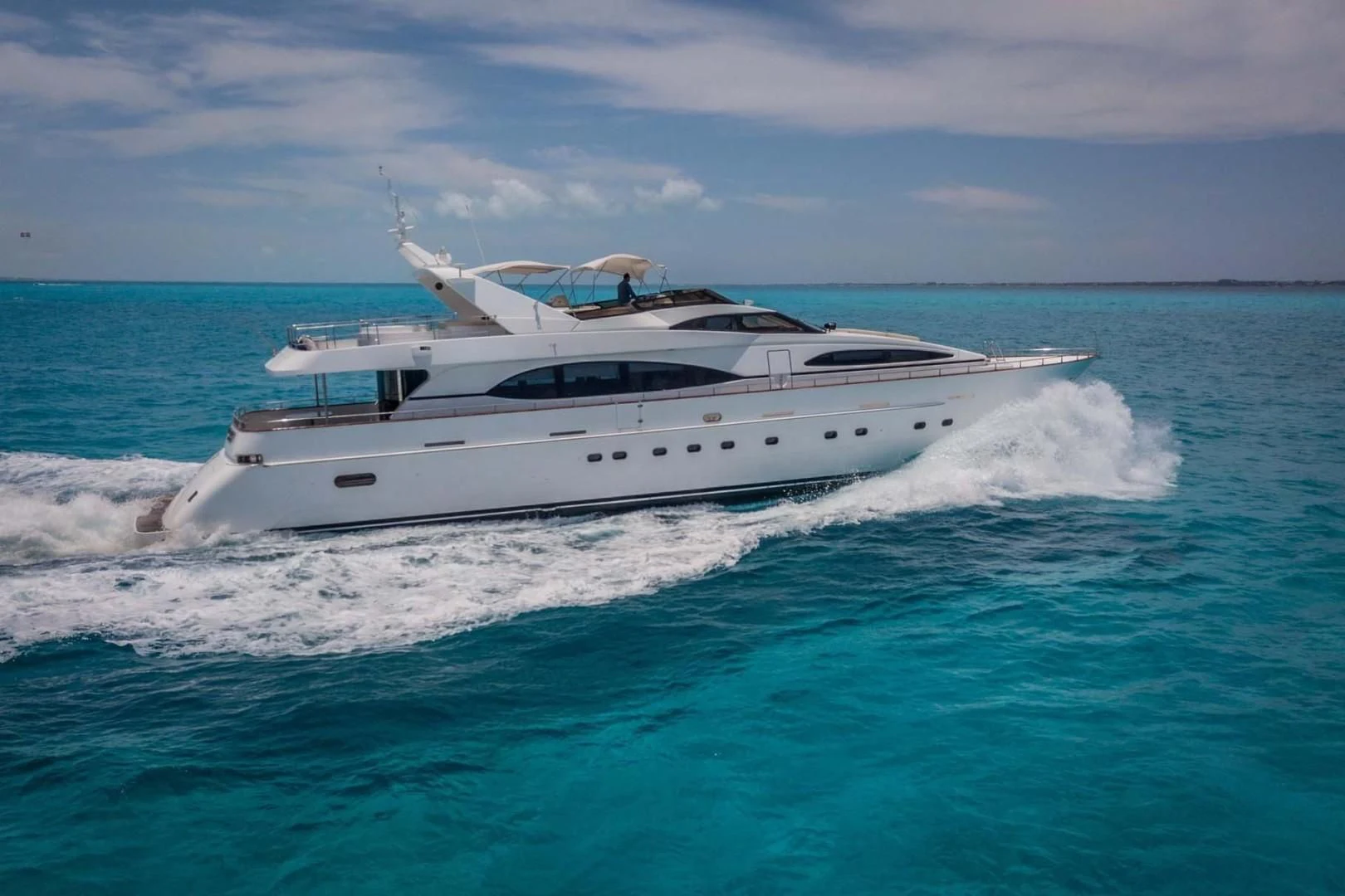 a white yacht on the water aboard EL CAPRICHO Yacht for Sale
