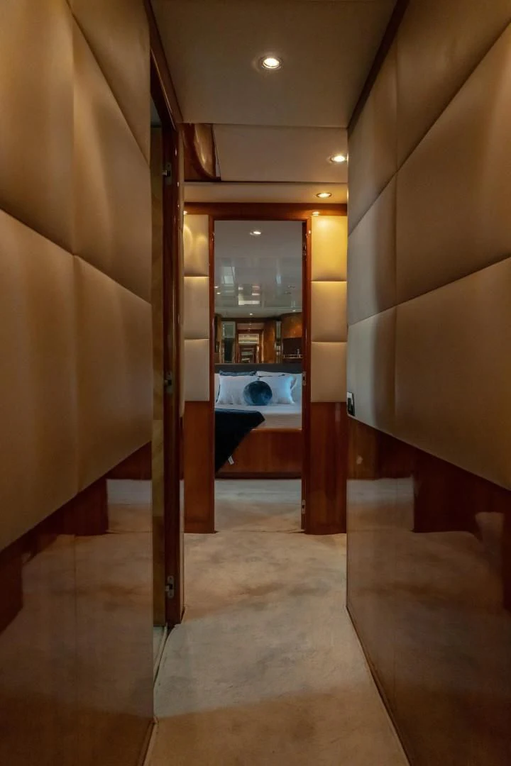 a hallway with a door and a mirror aboard EL CAPRICHO Yacht for Sale