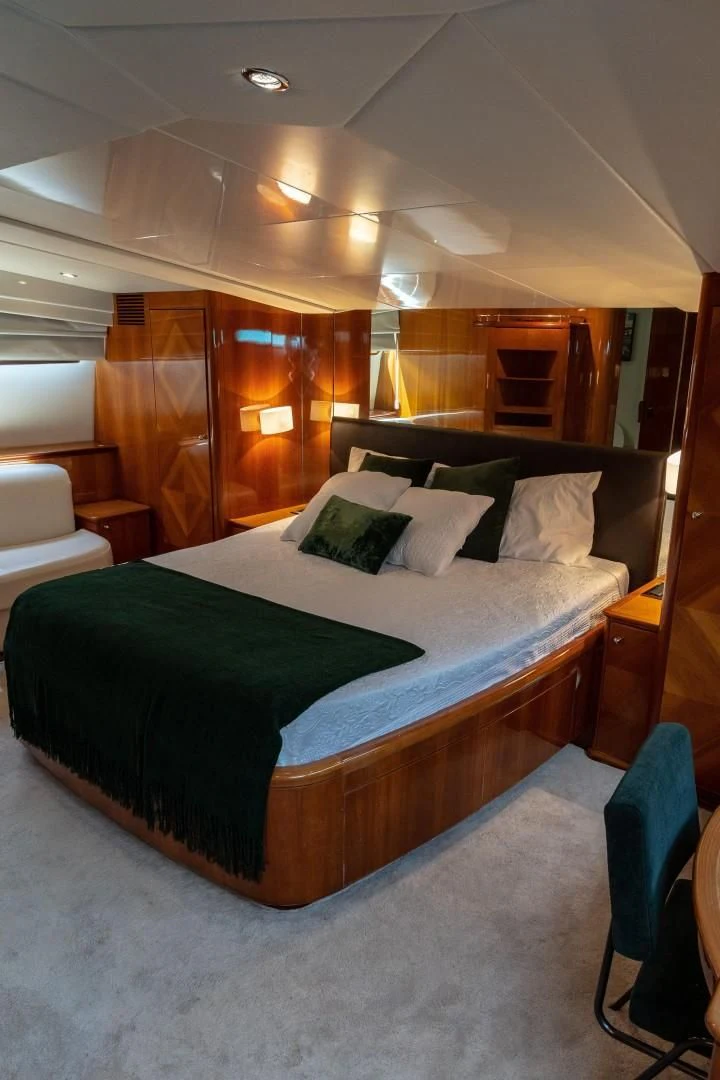 a bed with green sheets aboard EL CAPRICHO Yacht for Sale