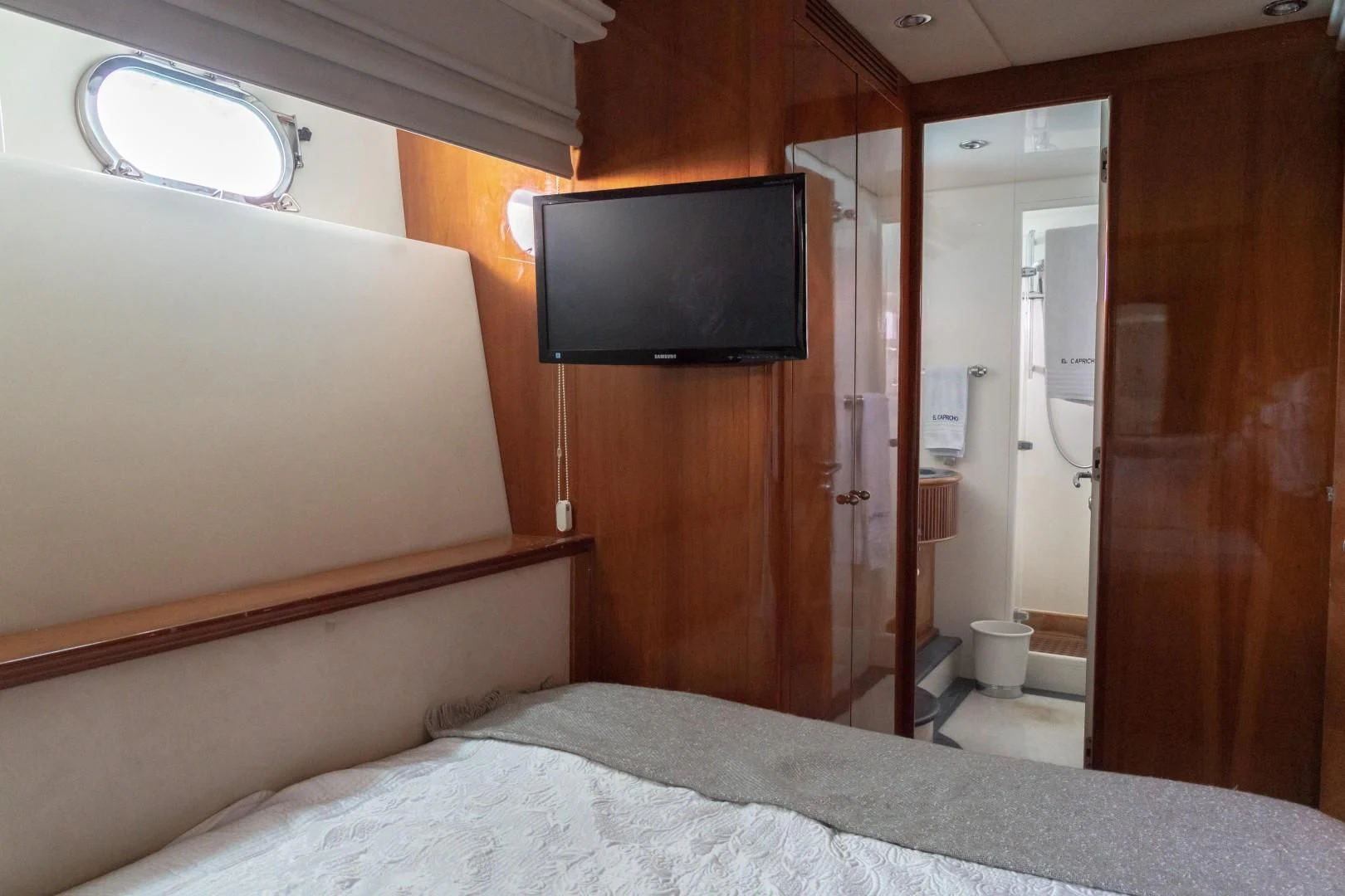 a bed and a television in a room aboard EL CAPRICHO Yacht for Sale