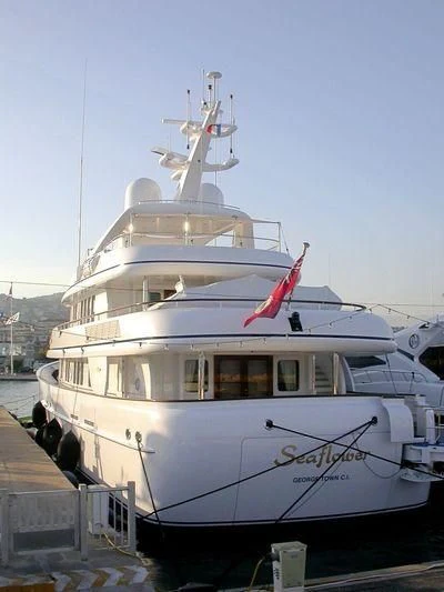a white boat with a red flag on it aboard CIPITOUBA Yacht for Sale