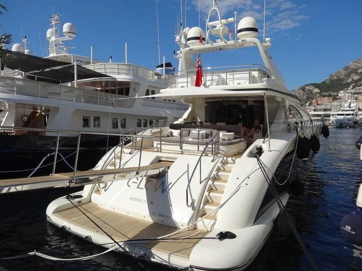 a boat docked at a pier aboard GLOW Yacht for Sale